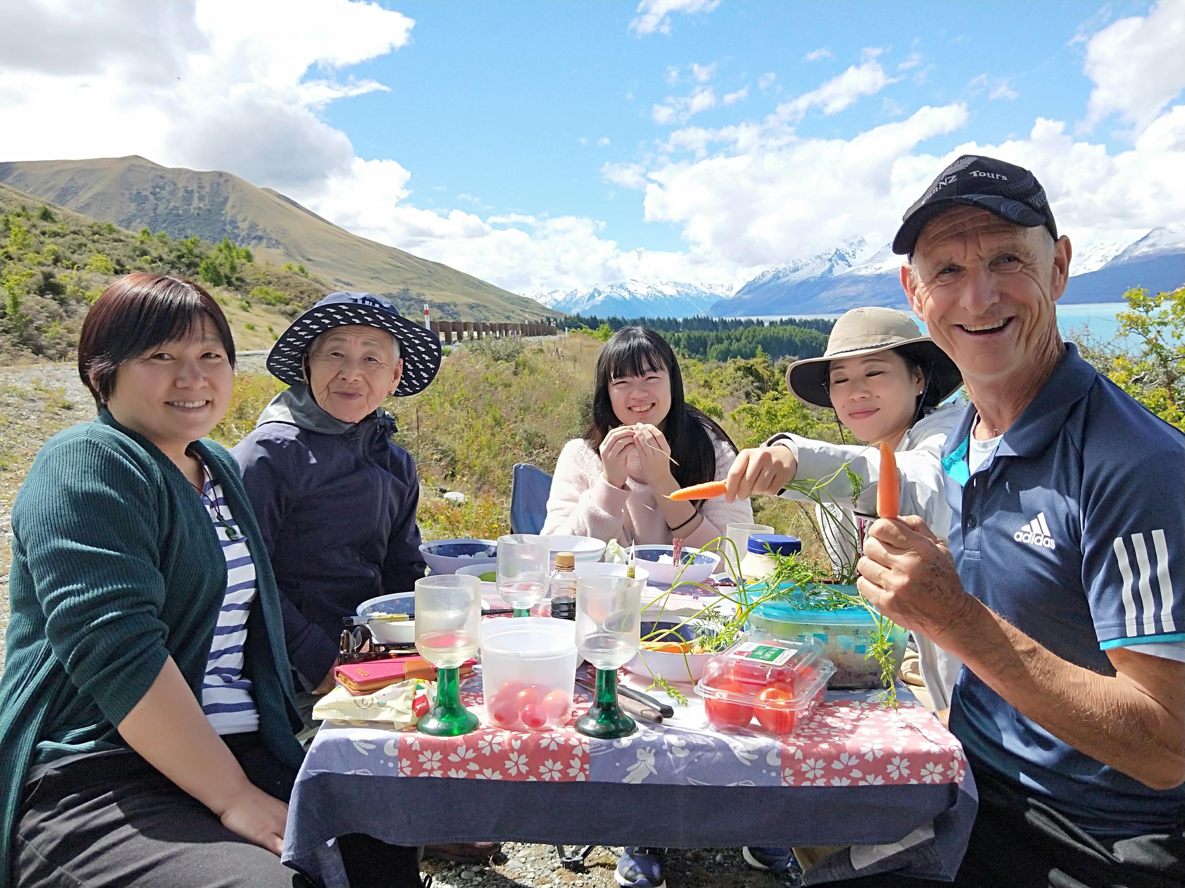 Happy customers having a picnic in the Southern Alps.